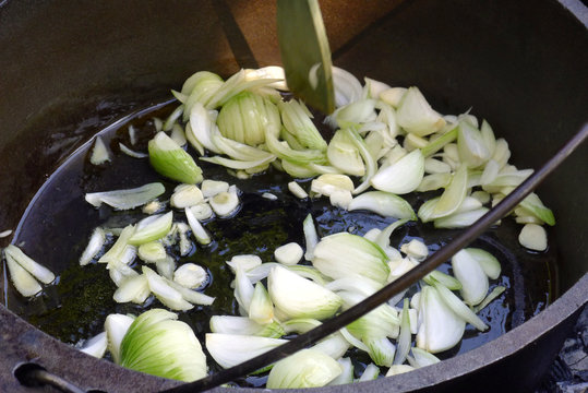 frying fresh onios in the garden on open fire