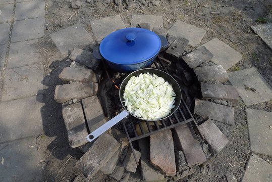 frying fresh onios in the garden on open fire