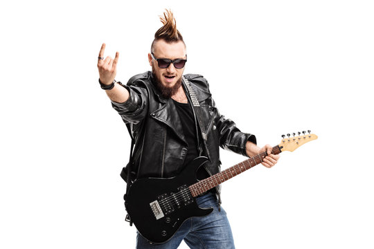 Punker with an electric guitar making a rock hand gesture
