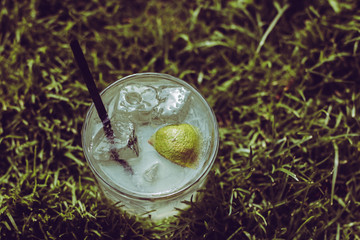A Fresh summer lemonade with lime on grass