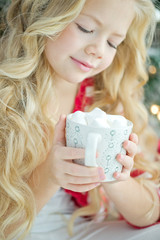 A child at Christmas with a mug  