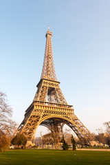 Fototapeta na wymiar Eiffel tower against blue sky at sunrise in Paris - France