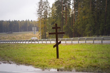 Christian cross near a road