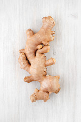 Big ginger root on the white wooden table