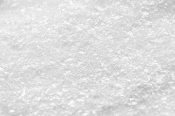 Texture of white snow with sparkles. Background for New Year's greeting card.
