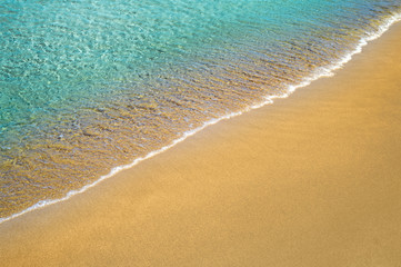 Fototapeta na wymiar Sand beach water edge summer background.
