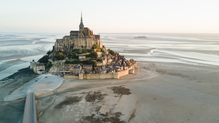 Le Mont Saint Michel tidal island in beautiful twilight at dusk, Normandy, France shot from aerial...