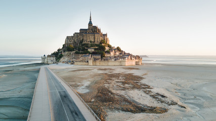 Le Mont Saint Michel tidal island in beautiful twilight at dusk, Normandy, France shot from aerial...