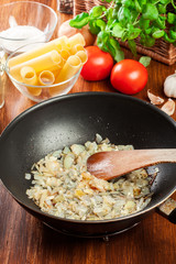 Fried onion and garlic in the frying pan. Preparation cannelloni