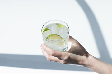 person holding glass with cocktail