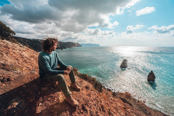 Fototapeta premium Man traveler over cold sea landscape