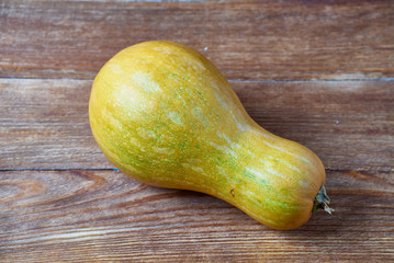 Yellow pumpkin on rustic wooden background