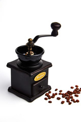 Manual coffee grinder./A hand grinder with coffee beans.