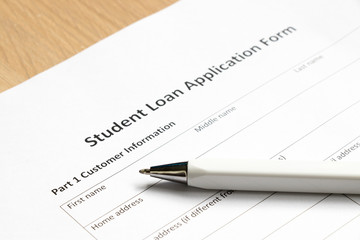 Student loan application form wth pen on desk background