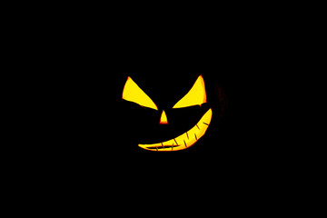 Autumn Pumpkin Thanksgiving Background - orange pumpkins over wooden table. Pumpkin on a black background. Autumn product. Carved pumpkin for Halloween.