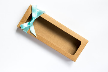 Brown craft paper as mockup box with blue bow on white background
