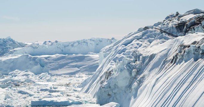 Iceberg from glacier in arctic nature landscape on Greenland. Aerial video drone footage of icebergs in Ilulissat icefjord. Affected by climate change and global warming.