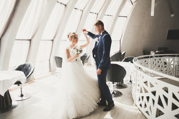 Perfect couple bride, groom posing and kissing in their wedding day