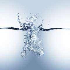 Dramatic blue water splash, water drops and air bubbles isolated on white