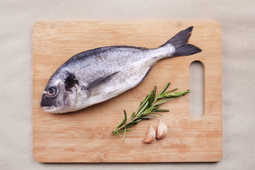 Fresh dorado fish seafood on wooden plank