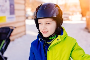Fototapeta na wymiar boy in helmet preparing for skiing