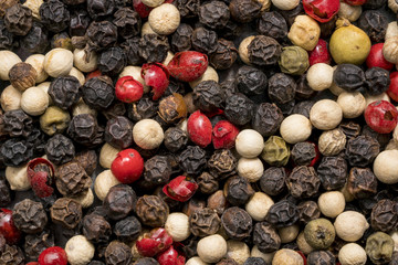 Close up shot of different colored peppercorns