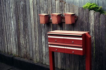 Apartment red mail box on wooden wall