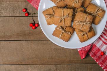 Biscuits, red berries, bumps, gifts, Christmas decor with free space for text. Top view