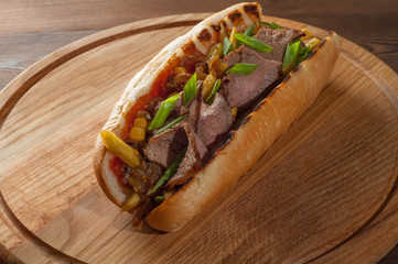 Big sandwich on a wooden kitchen board