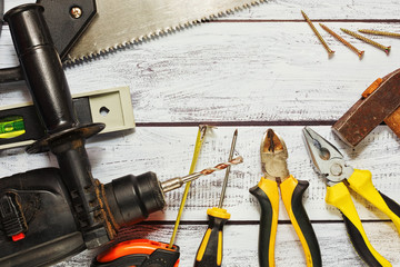 Different working tools on wooden background