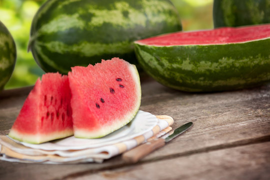 Big watermelon slices on wooden table