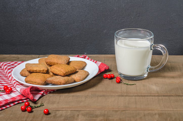 Biscuits, milk, red napkin, Christmas decor with free space for text.