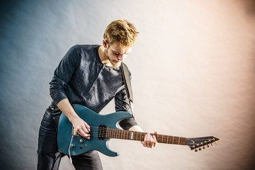 Obraz premium Young man playing electric guitar