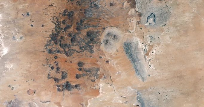 Very high-altitude overflight aerial of otherworldly landscapes near New Mexico's Potrillo Volcano. Clip loops and is reversible. Elements of this image furnished by USGS/NASA Landsat