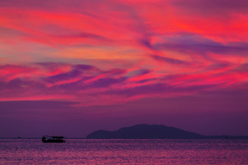 Purple sunset in Sanya, Hainan, China. Colorful madness from the clouds, merging with the sea.