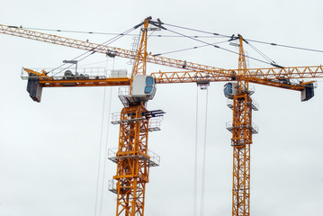Large construction crane builds a house