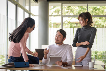 young asian businessman working with team in office