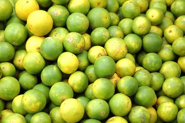 many fresh yellow and green lemon in bazaar