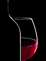 Elegant silhouette bottle of  red wine and glass on black background - 175960252
