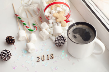 wooden date 2018, A cup with coffee, ginger bread, marshmallow. Cozy winter home background