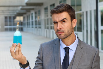 Cocky businessman holding a potion