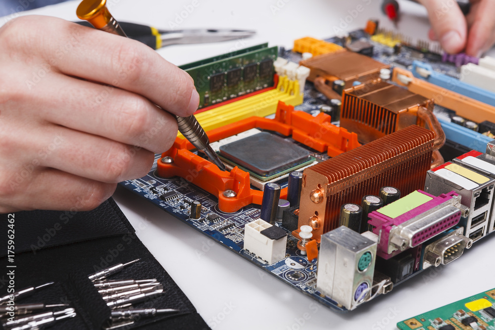 Poster engineer checking motherboard with multimeter