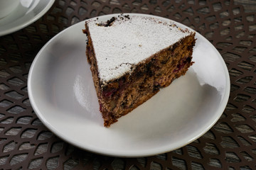 Slice of homemade cranberry cake with walnuts