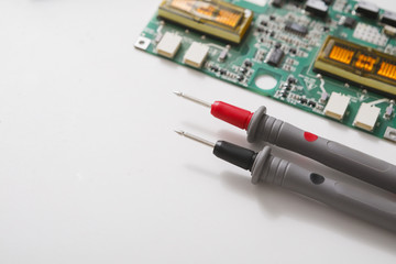 Multimeter and broken electronics at repair shop