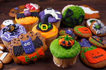 Happy Halloween cupcakes and cookies.Composition with Halloween sweets, holiday treats concept