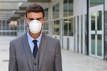 Businessman using an anti-pollution mask 