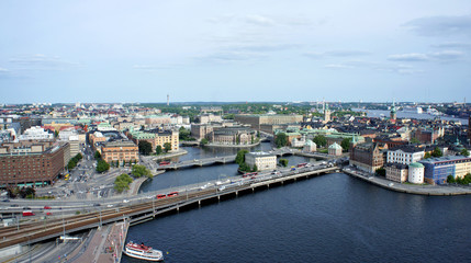 Fototapeta premium Aerial view of roads with car traffic and beautiful cityscape from the observation deck of Town Hall, way to Gamla Stan, Stockholm, Sweden