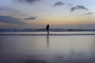 attractive african american black woman walking on sunset beach
