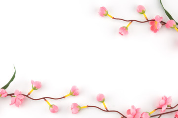 Fake pink flower branches on white background with copy space