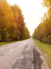 Autumn road car . Terrible pavement on the road in rural areas . Russian roads